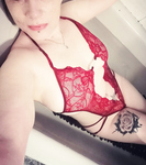 In red bodysuit in bathtub