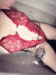 In red bodysuit in bathtub